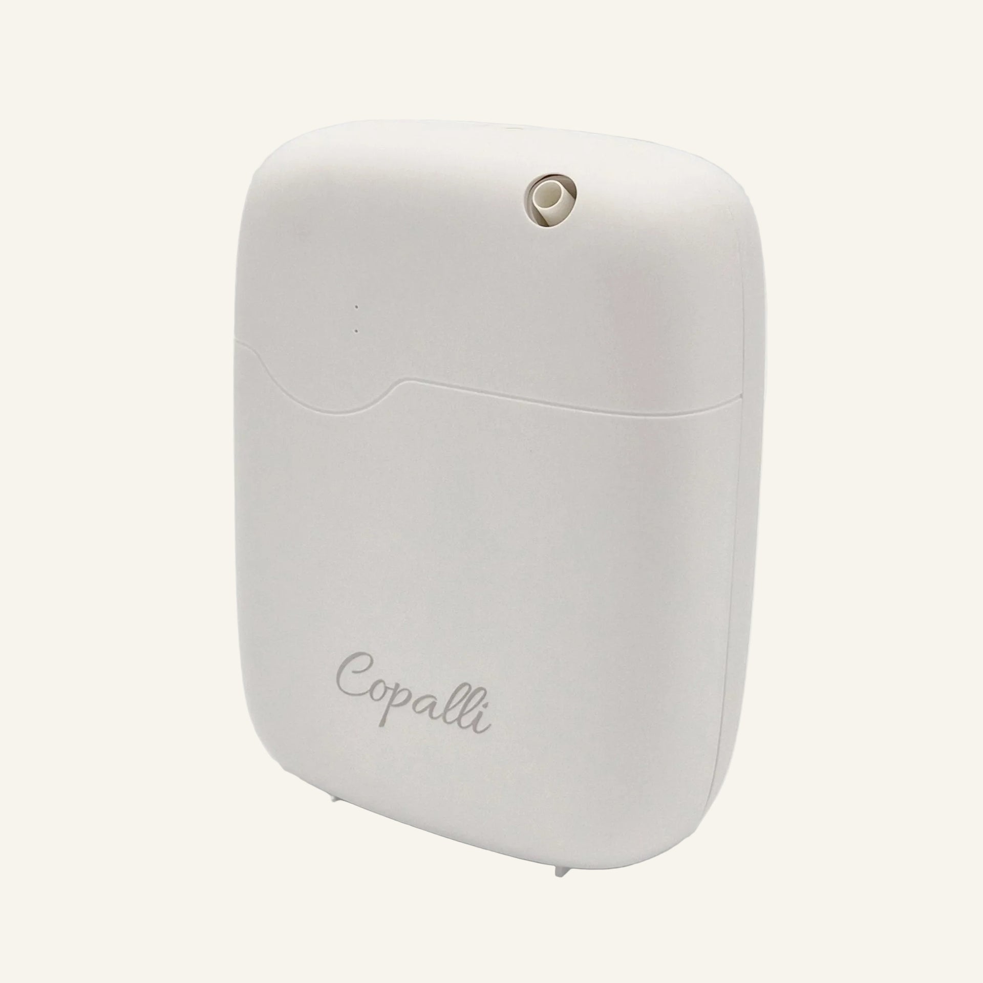 Our white Copalli Home Diffuser shown from a side profile, featuring a compact, rounded waterless design with a minimalist 'Copalli' logo on a light cream background.