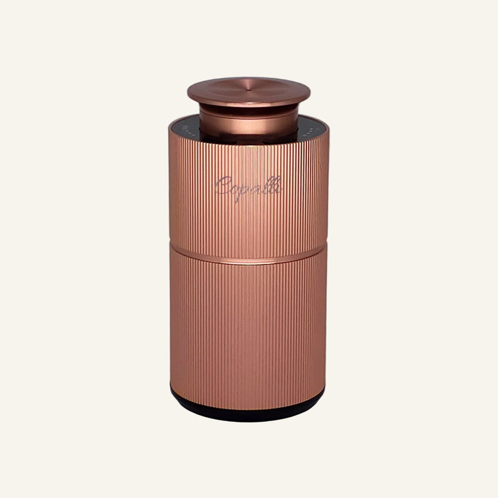 Our Rose Gold Copalli Mini with "Copalli" branding; waterless scent diffuser with fine vertical ridges. 
