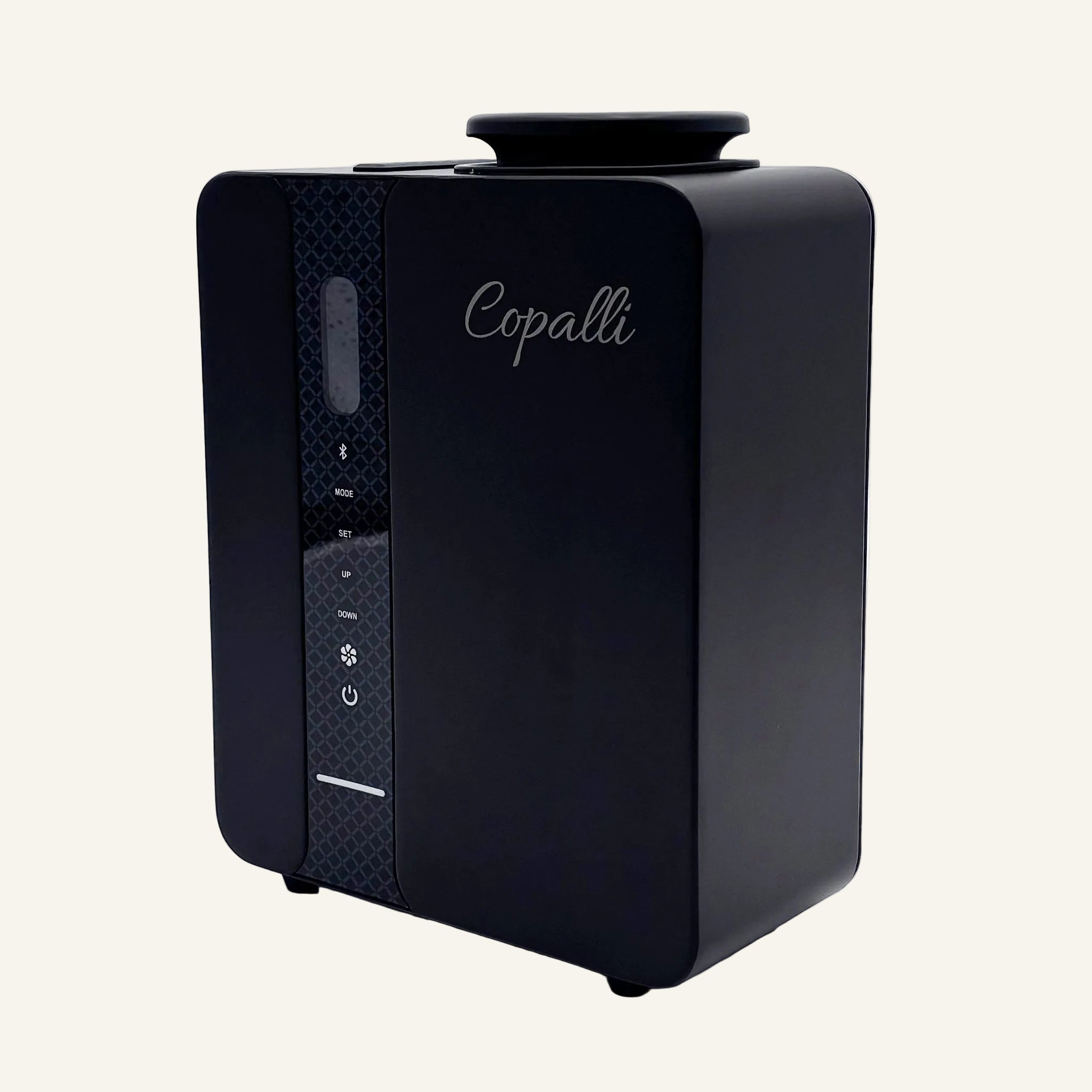 Our black Copalli Pro Diffuser featuring a sleek, rectangular industrial design with a textured side panel and the 'Copalli' logo, centered on a minimalist light cream background.