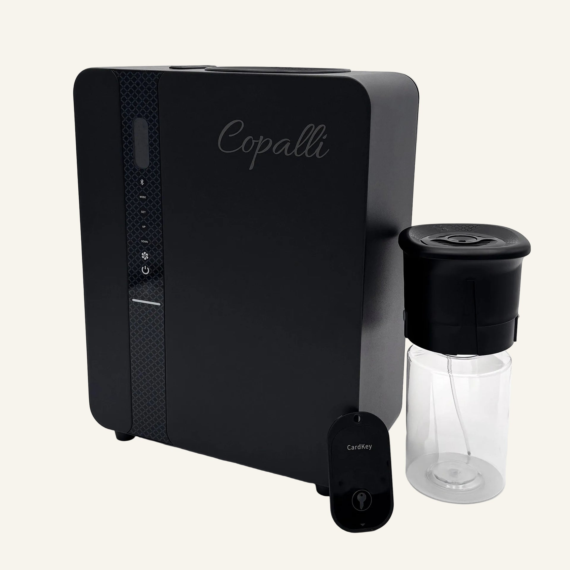 Our black Copalli Pro Plus Diffuser shown from a side profile with its 500ml fragrance bottle and remote control, highlighting its sleek, industrial waterless design for large-scale scenting.