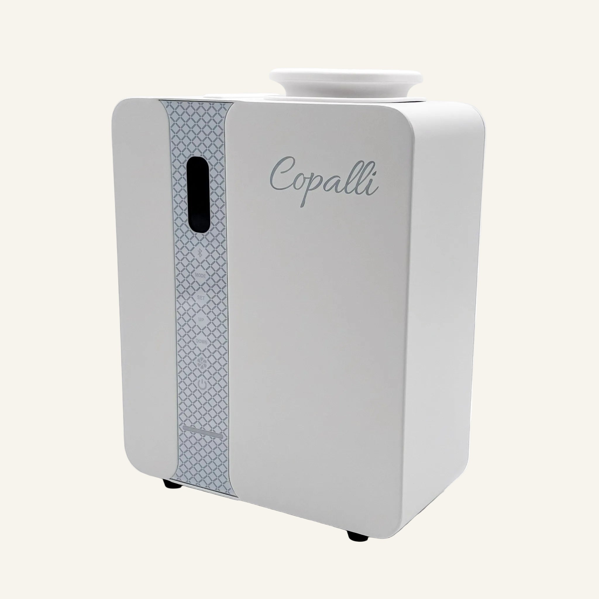 Our white Copalli Pro Diffuser featuring a sleek, rectangular industrial design with a patterned side panel and 'Copalli' branding, centered on a minimalist light cream background.