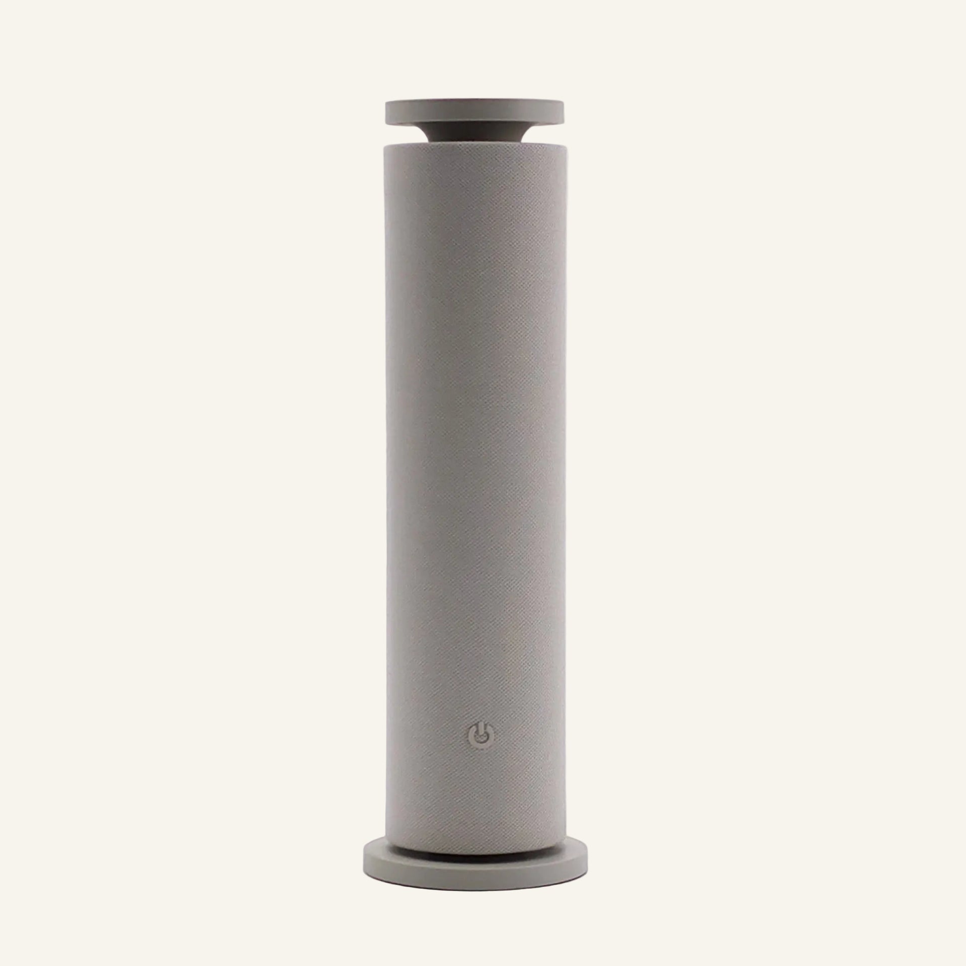 Our Beige Copalli Tower Diffuser featuring a tall, slender cylindrical design with a minimalist matte finish and a discreet power icon, centered on a light cream background."