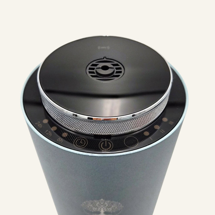 Top view of the Tower Pro Diffuser by Copalli, highlighting the sleek black circular control panel and metallic mesh detail on a professional-grade aluminum body."